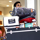 male student moving in with lots of boxes