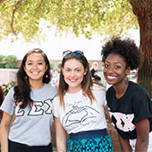 three girls smiling at the camera