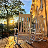 rocking chairs on the porch watching the sunset