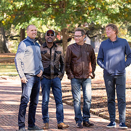 4 members of the Hootie & the Blowfish standing on the Horseshoe