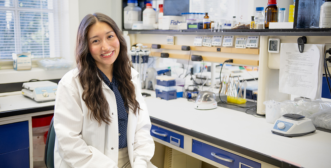 Hannah Brennen in a white lab coat.