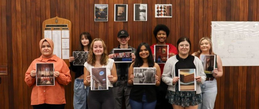12 student winners of University of Libraries hold up their pictures.
