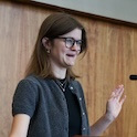 Research award recipient speaking at podium.