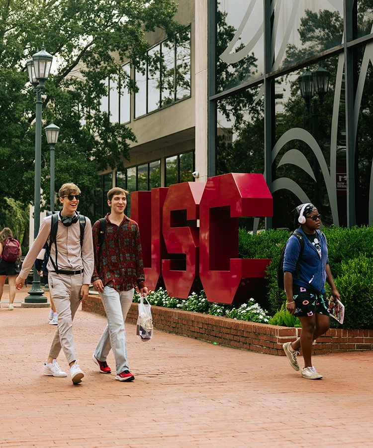 Students walk past the USC sculpture on the University of South Carolina campus.