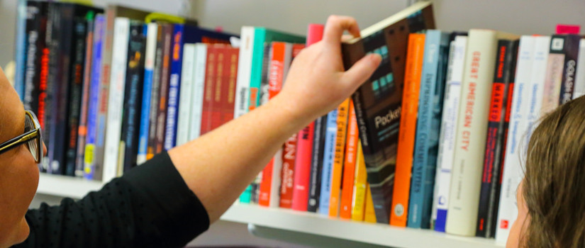 Students looking at criminology books