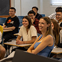 photo of students smiling in a classroom