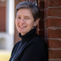 Headshot of Robin Waites leaning against a brick building.