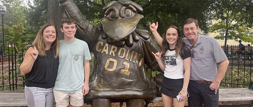 Amy Jordan and family pose in front of the Cocky Statute