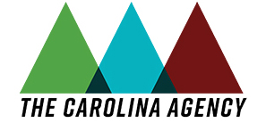 Formal logo - three slightly overlapping triangles, side by side, in the following order from left to right; Green, Blue and Red. Where the triangles overlap it is colored Black. Beneath the triangles is written The Carolina Agency.