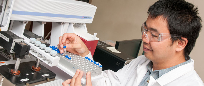 male grad student works in a lab