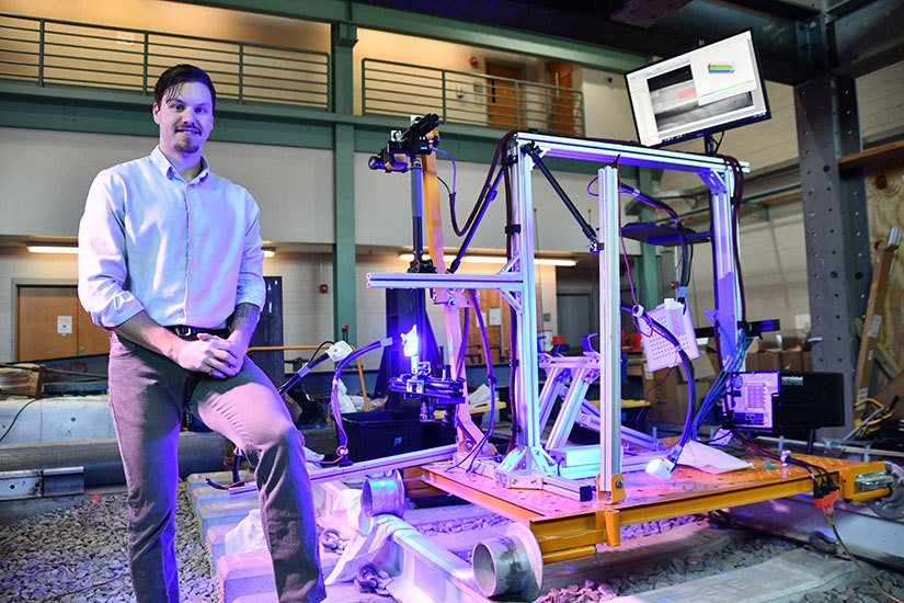 Gedney stands next to a prototype for his research