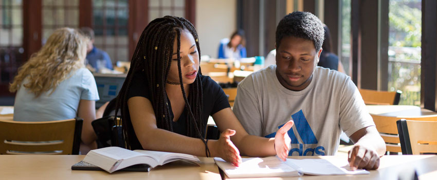 Two students work together at a table