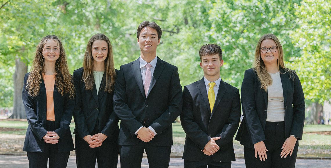 Group photo of students in business professional attire.