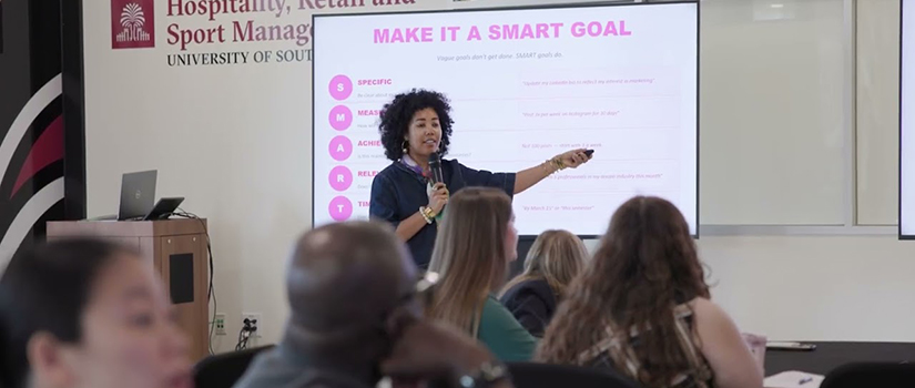 A presenter at Career Tracks speaks to an audience while giving a presentation.