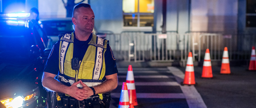 Police officer on duty standing at night