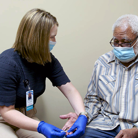 Pharmacists with a patient