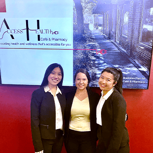 Group of three students in front of a television screen