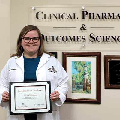 Macie Goodman holding certificate