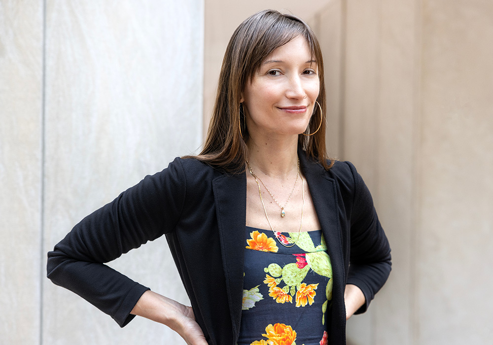 Monica Barra stands outside a building