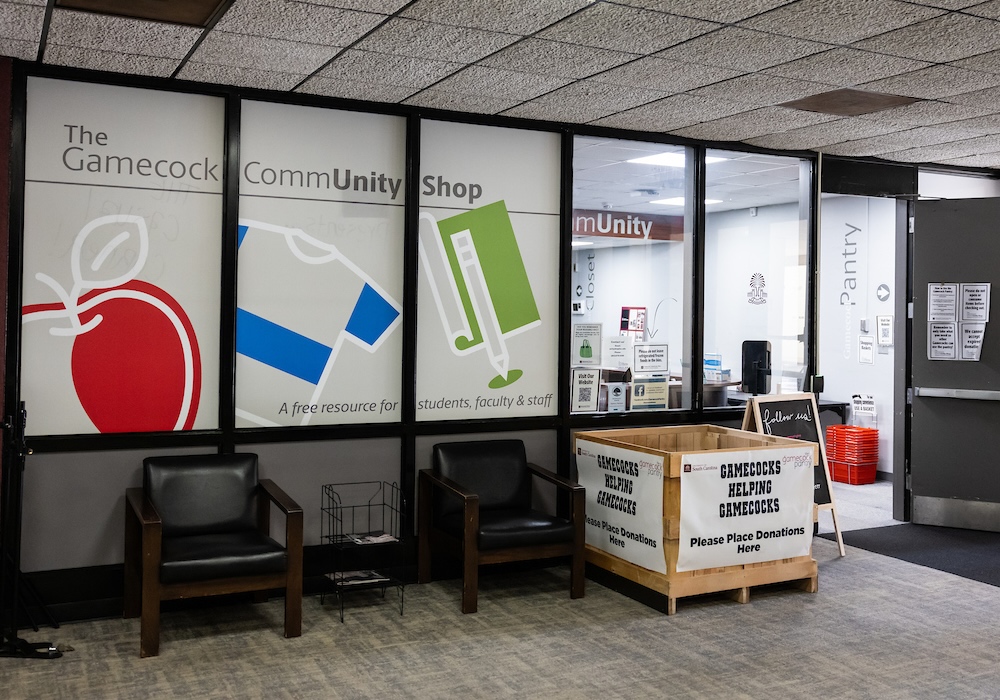 sign in front of shop that reads gamecocks helping gamecocks