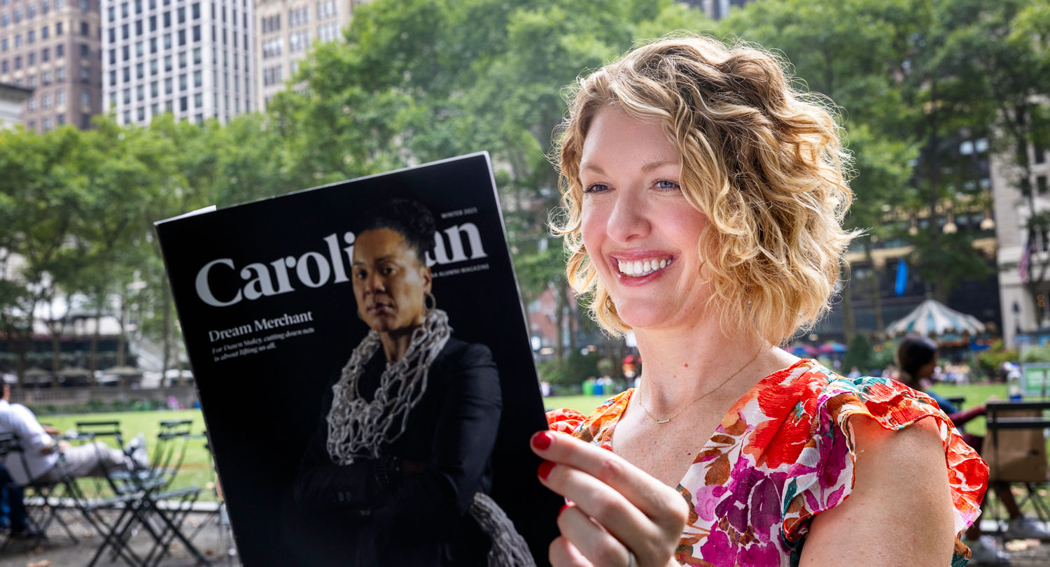 Sara Bako reading Carolinian magazine in Bryant Park.