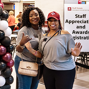 Two staff members pose in the Russell House during Staff Appreciation and Awards Day