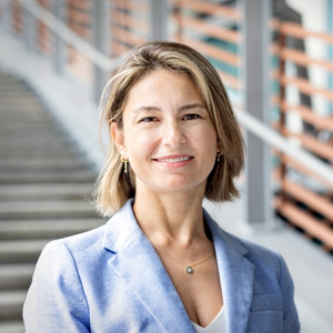 Professor Ayse Ozturk smiles in the lobby of the Darla Moore business school